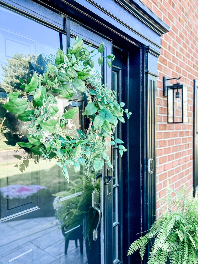Welcoming Front Porch Wreath hanging on a door