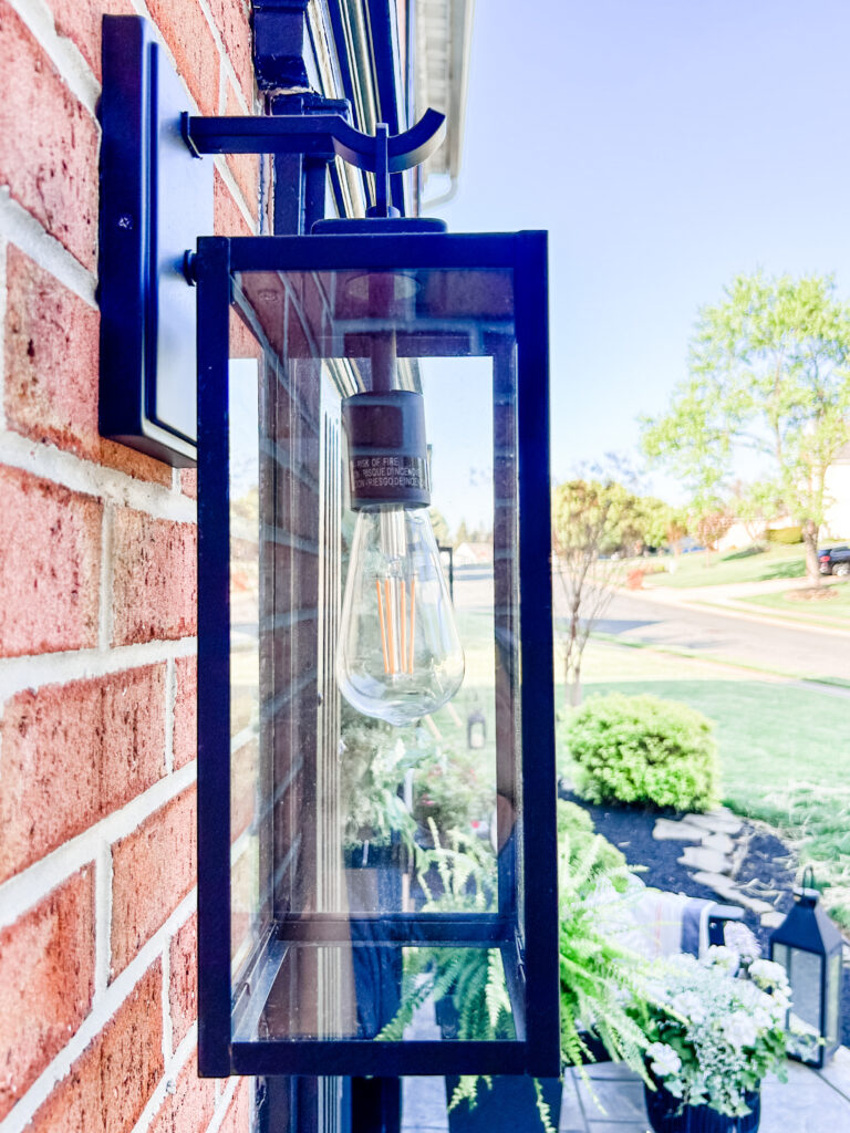 Welcoming Front Porch modern black rectangular outdoor wall sconce with a clear glass shade and light bulb