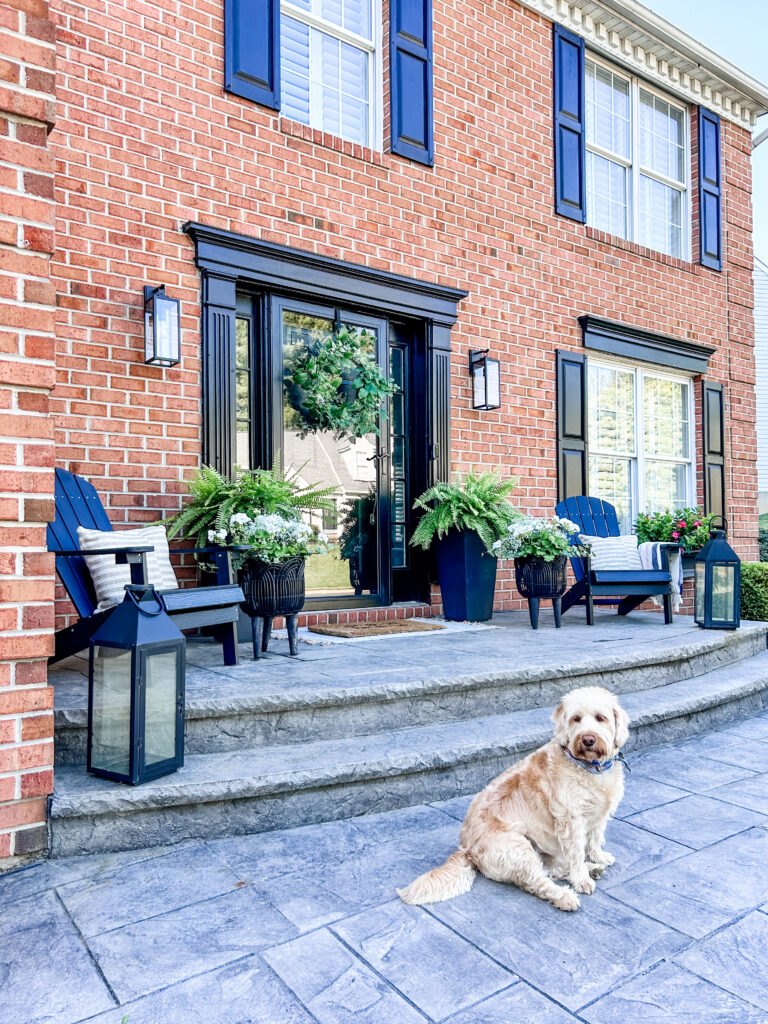 Welcoming Front Porch a modern front porch featuring Adirondack chairs and black planters